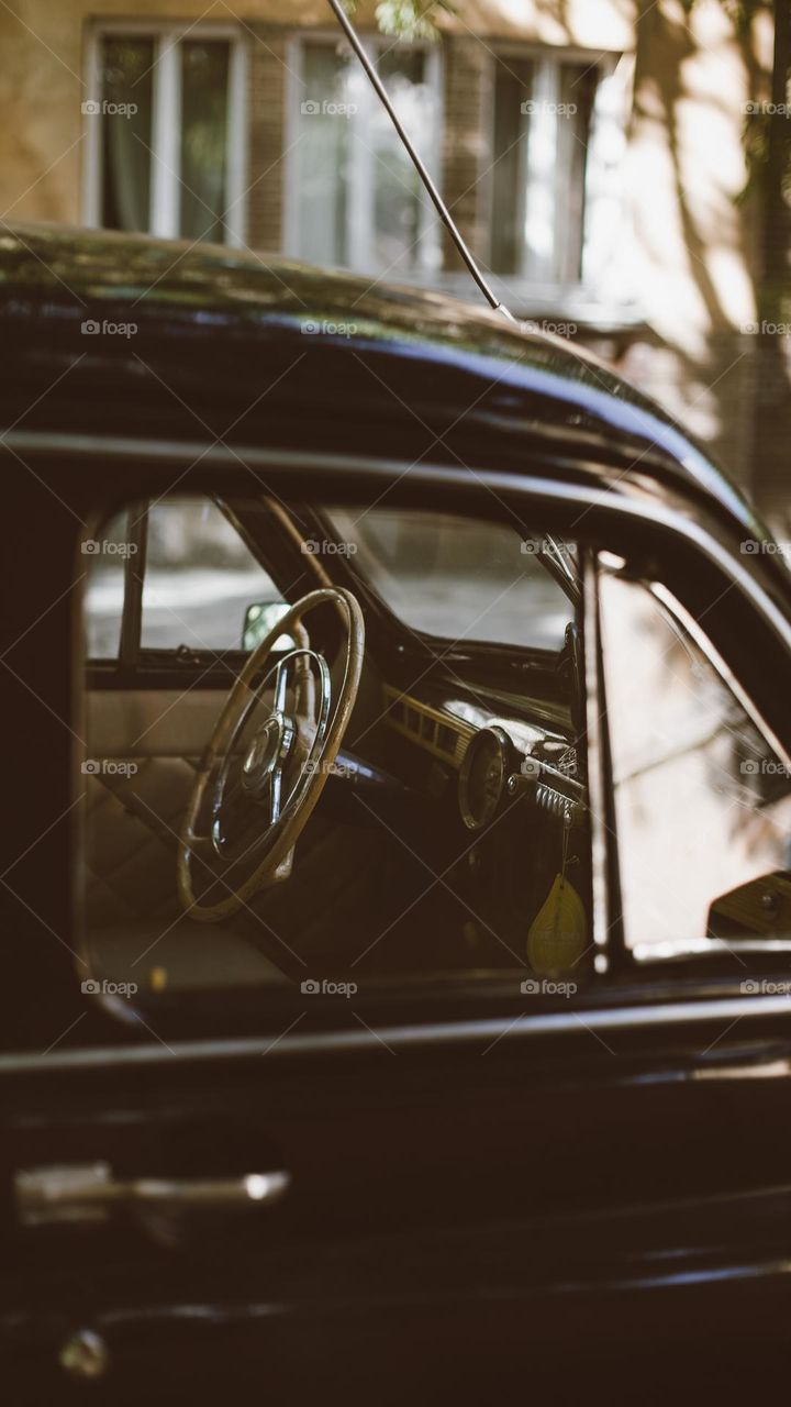 photo of the interior and control panel of a retro car decorated in warm colors