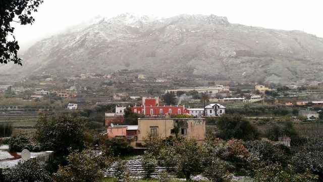 The view of Calitto with Piromallo Castle on the Italian island of Ischia on a snowy day