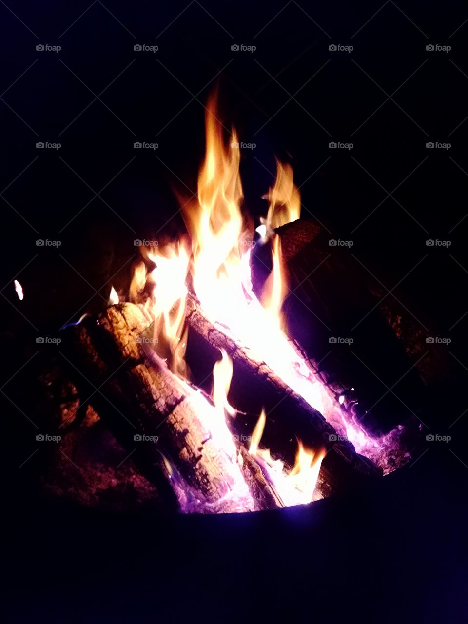 campfire at night. sitting around a campfire at night