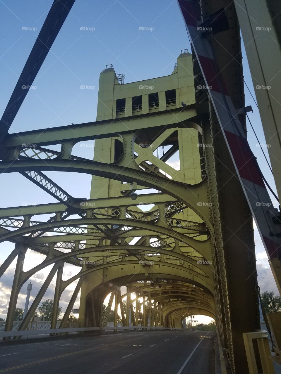 Old yellow Sacramento steel bridge at dusk