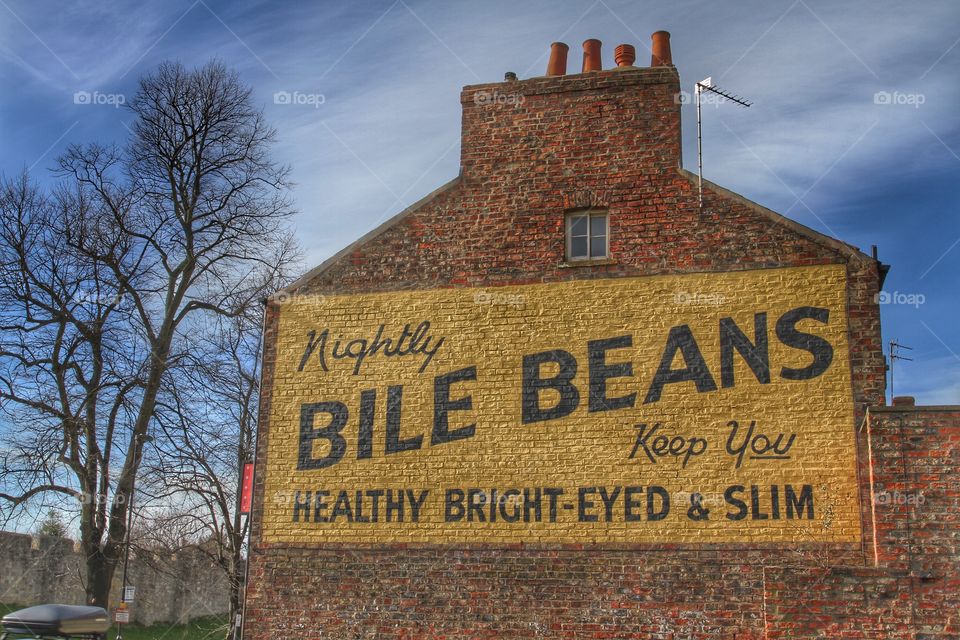 An antique advert painted on the side of a brick building in York.