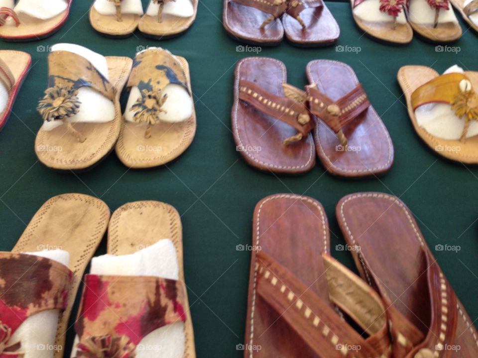 Shoes. Table full of flip flops
