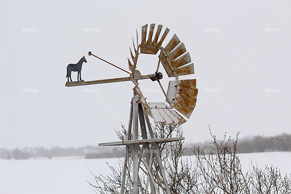 Weather Vane windmill. Weather vane windmill in the snow in Kansas. 