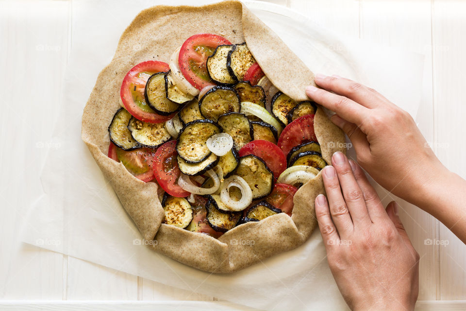 Cooking tartalet with eggplant, onion and tomatoes