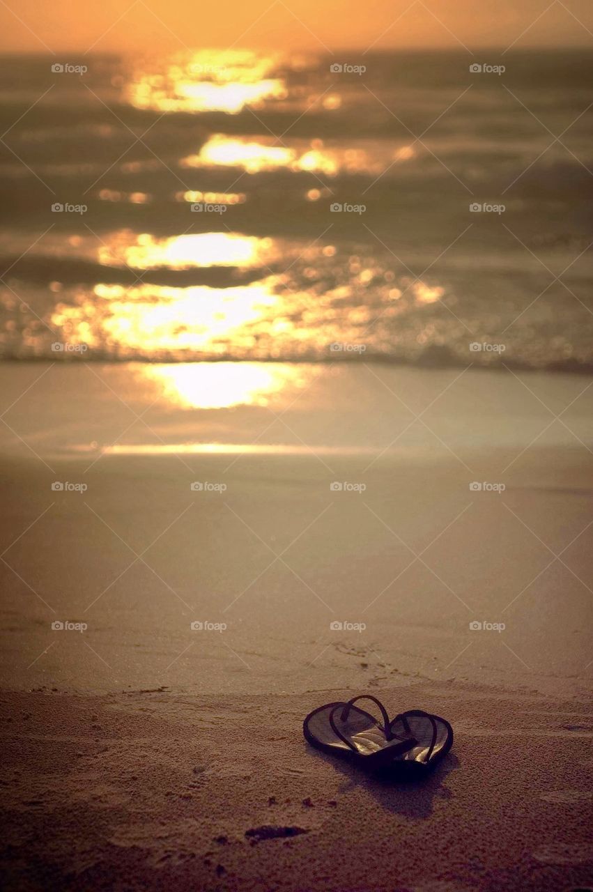 Footwear on sandy beach