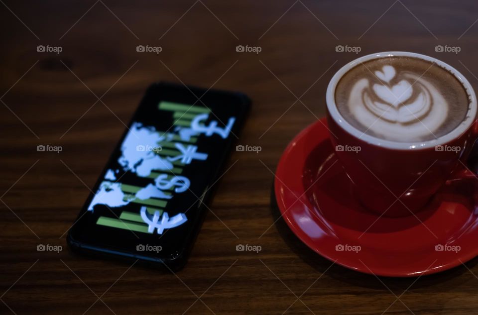 trading while enjoying a cup of coffee latte