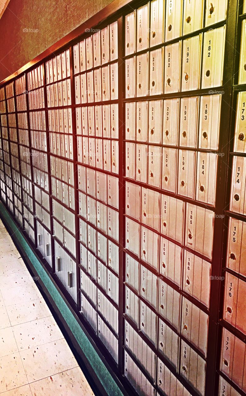 Post office, wall of mailboxes all closed.