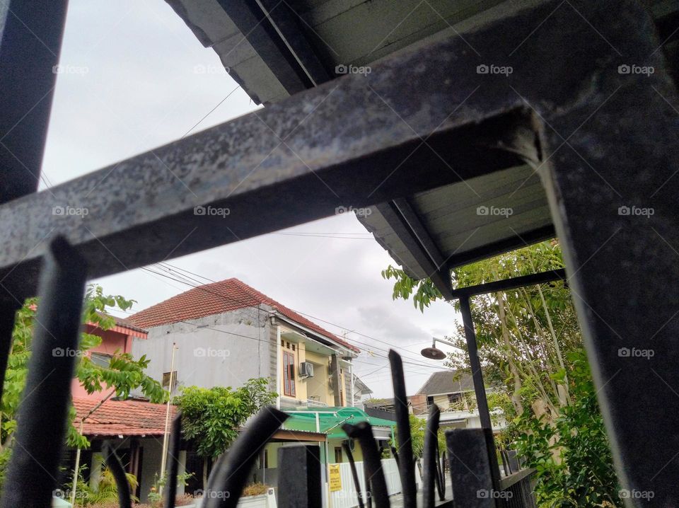 From behind the iron fence