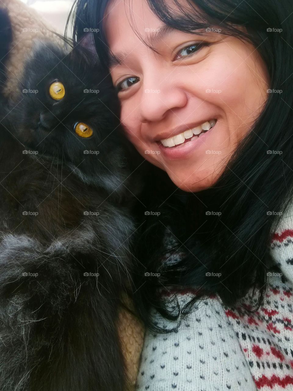 Lady selfie and is very happy with her cat. Friendship between human and cat. Concept of unconditional love and happiness.