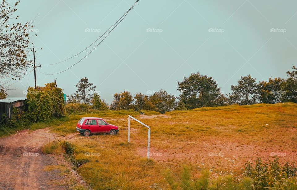 A red car parked in a playground