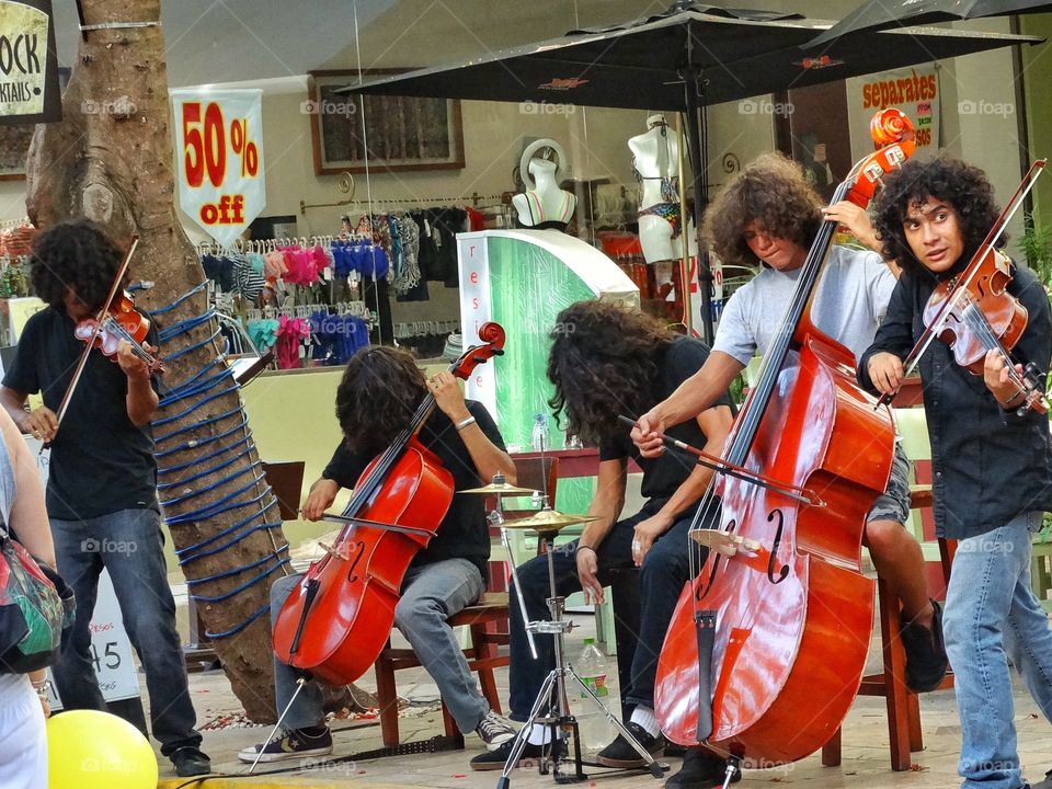 Mexican Street Musicians. Five Young Musicians Playing Instruments On A Boulevard In Cancún, Mexico
