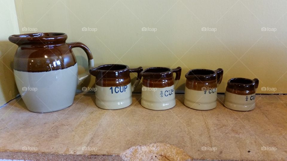 White and Brown pottery measuring pitchers