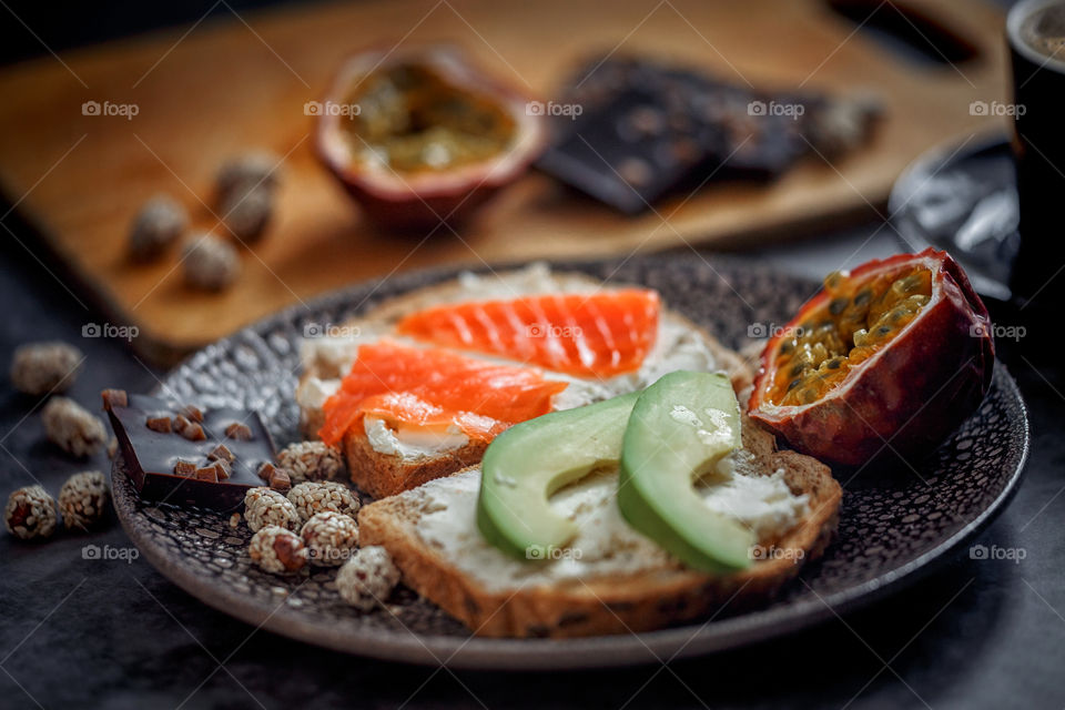 Dietary sandwiches of grain toasts with cream cheese, fish and avocado