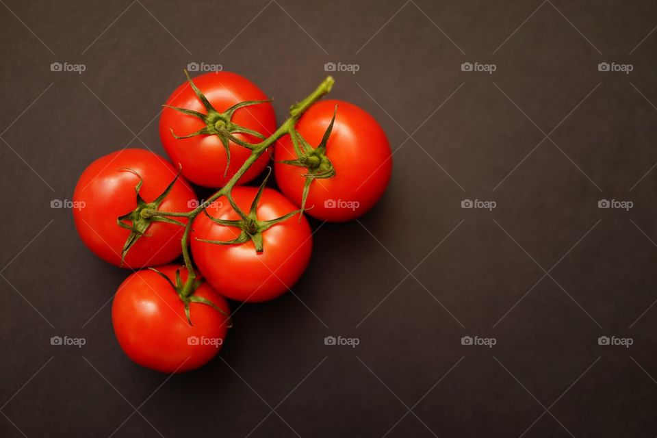 High angle view of tomatos against brown background