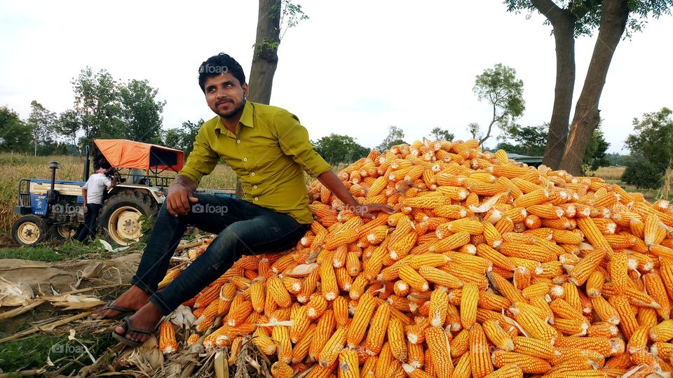 happy farmer with maize