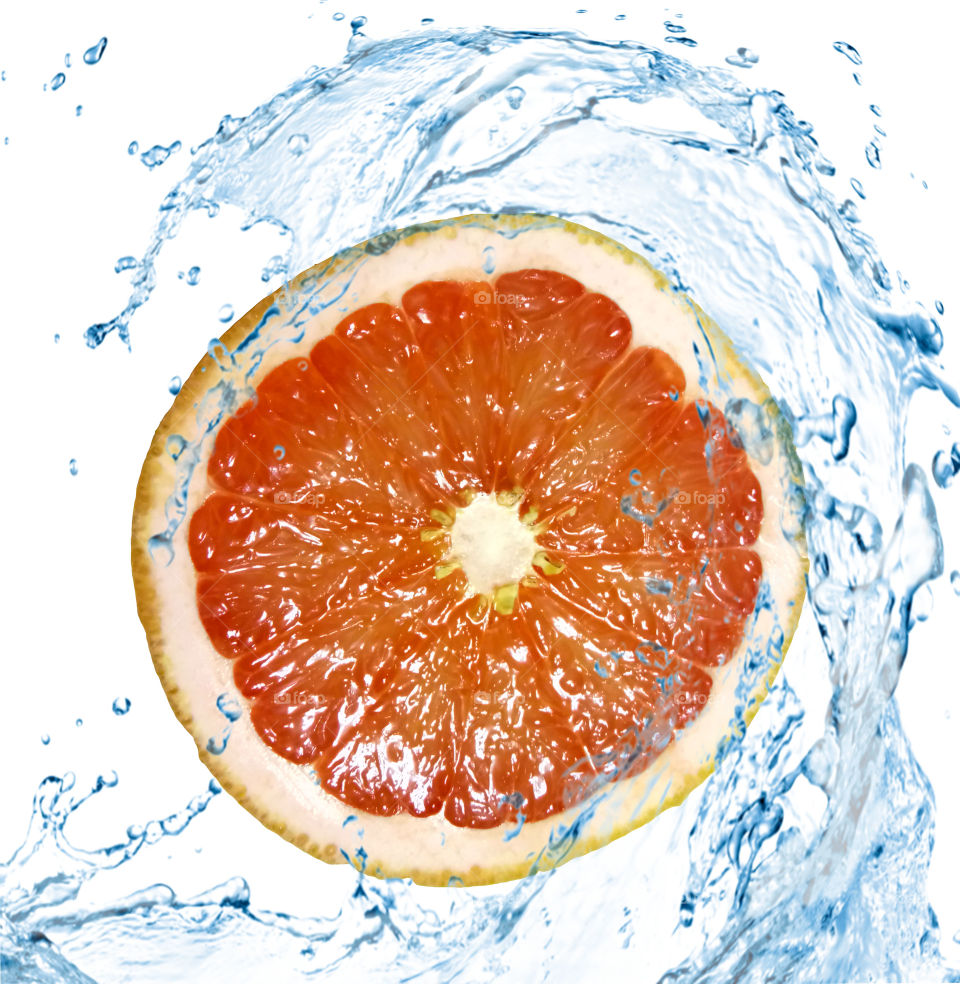 Grapefruit slice in water splashes on White background