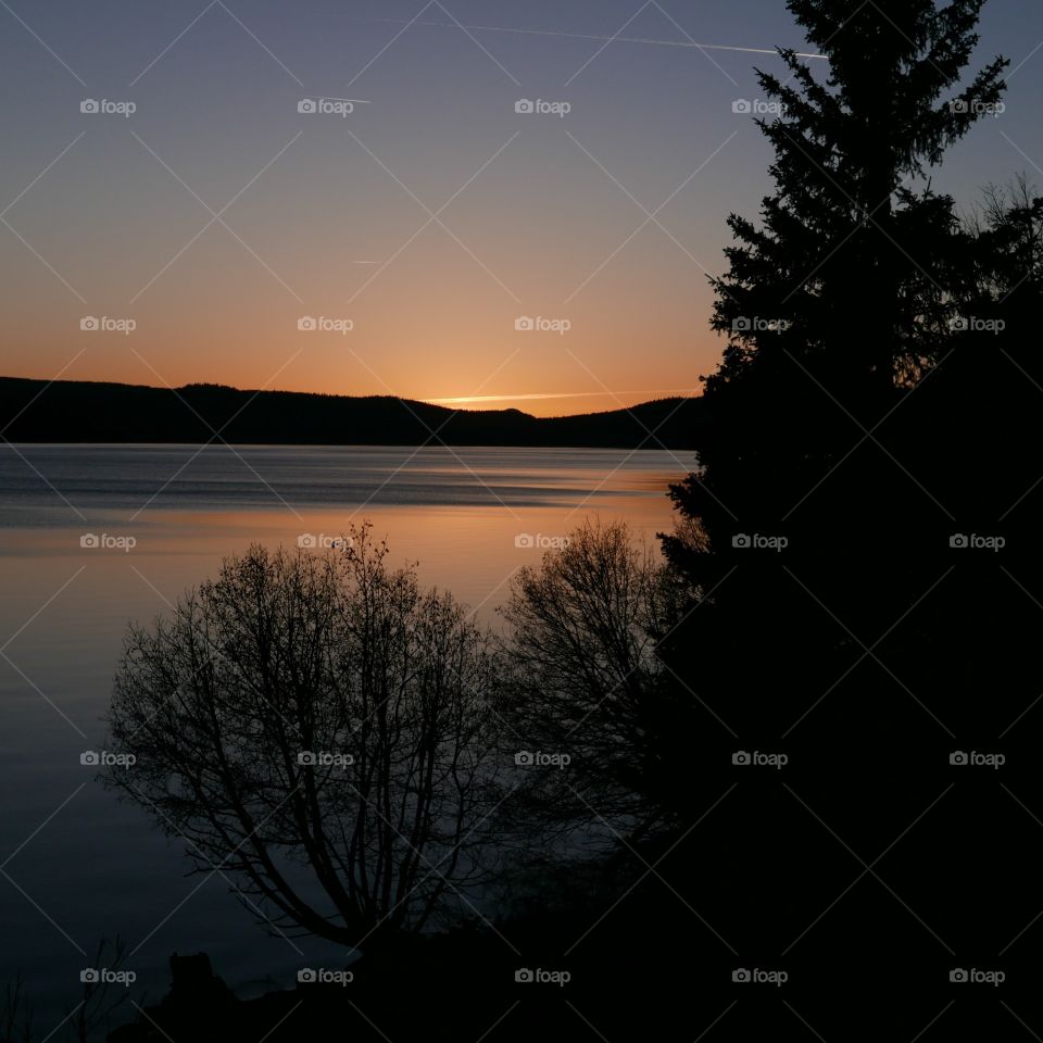 View of idyllic lake and mountain during sunset