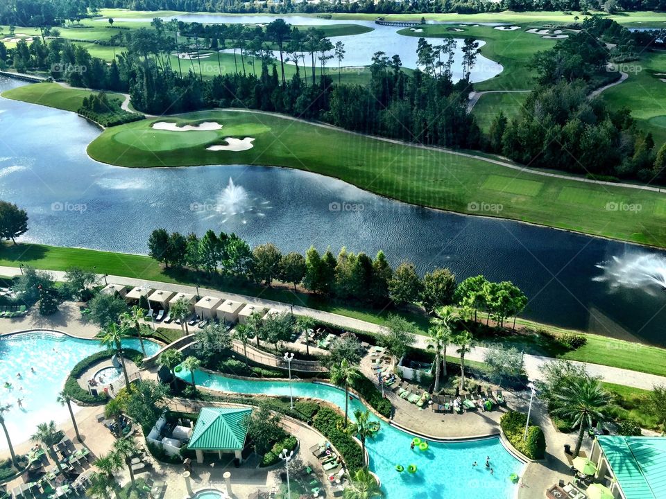 Birdseye view of resort and golf course with pool