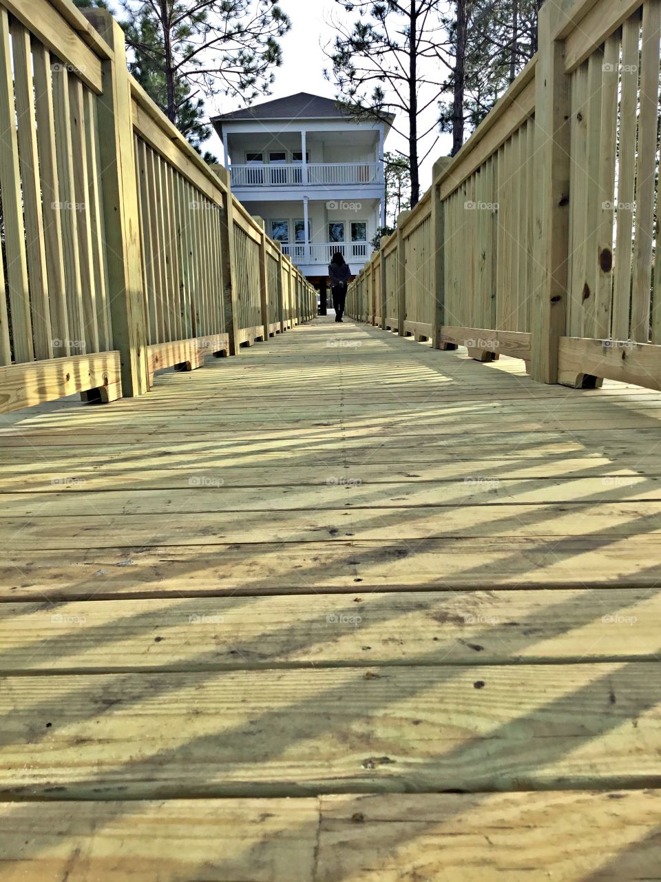 
Symmetry - The planked walkway from the bay to the house offers a charm that only wood can bestow, from weathered sand & sea styles to polished modern renditions.