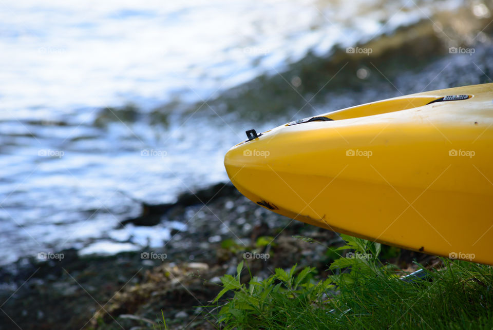 Boat kayak canoe on edge of water conceptual healthy lifestyle and summer adventure travel outdoor activity photography with room for copy space 