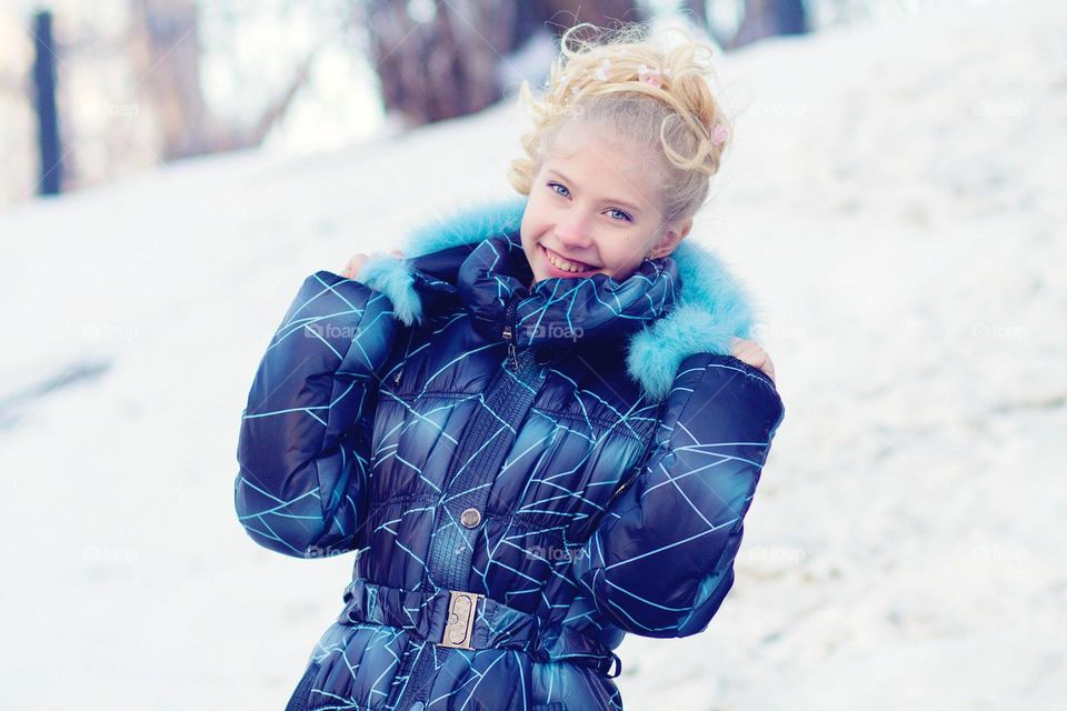 Portrait of a smiling girl wearing warm clothing
