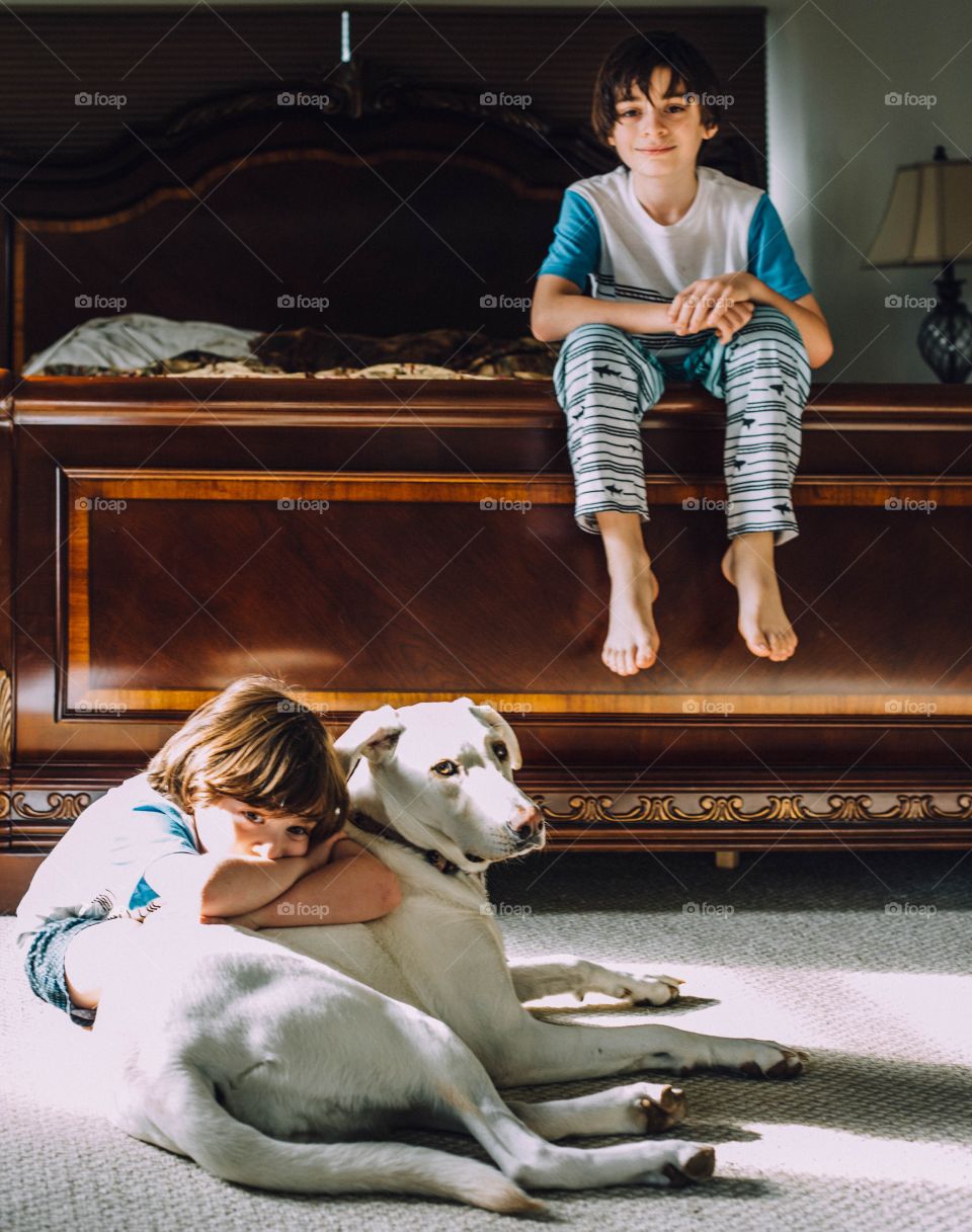 Brothers relaxing with their dog