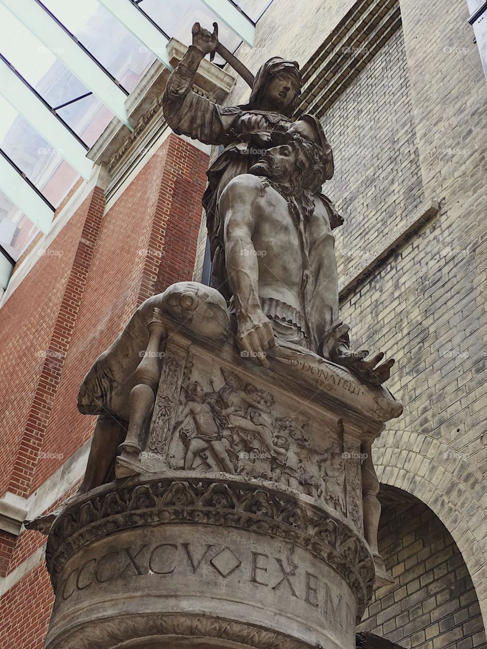 A statue in the Victoria and Albert museum, looking up at the woman, holding the sword.