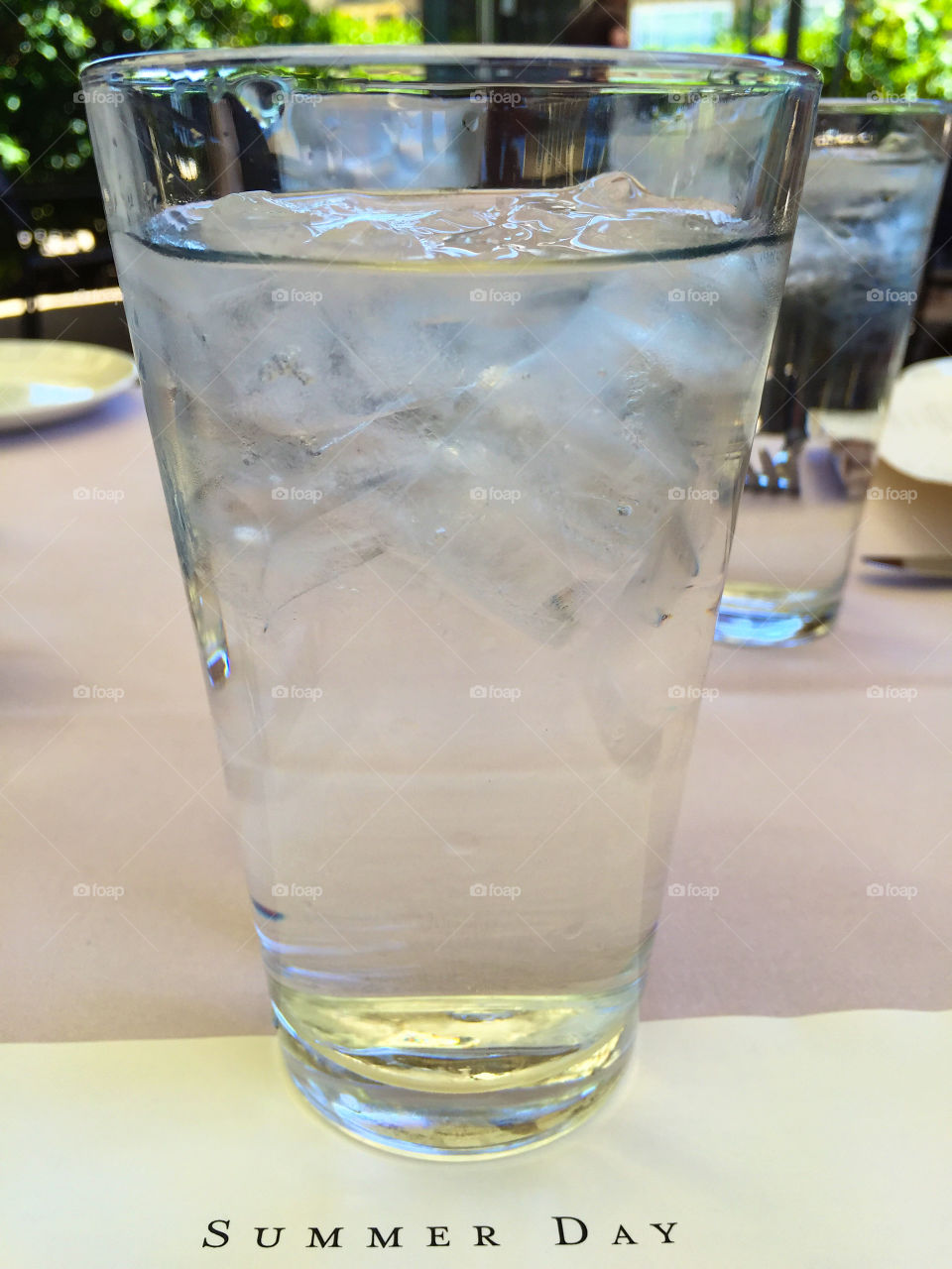 Summer Day. Menu and glass of cold ice water on a very hot summer day. 