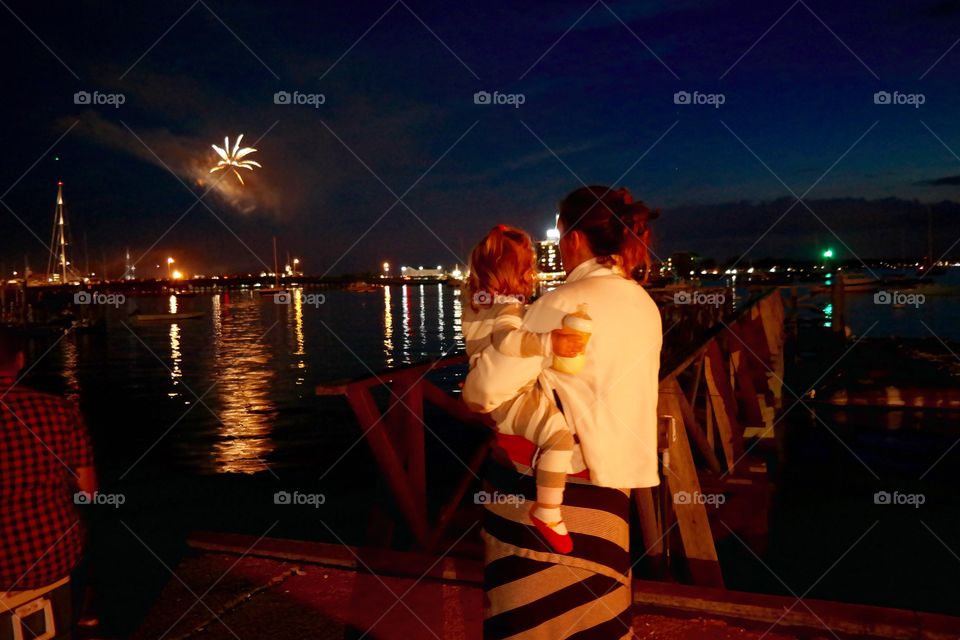 Mom and baby watching firework