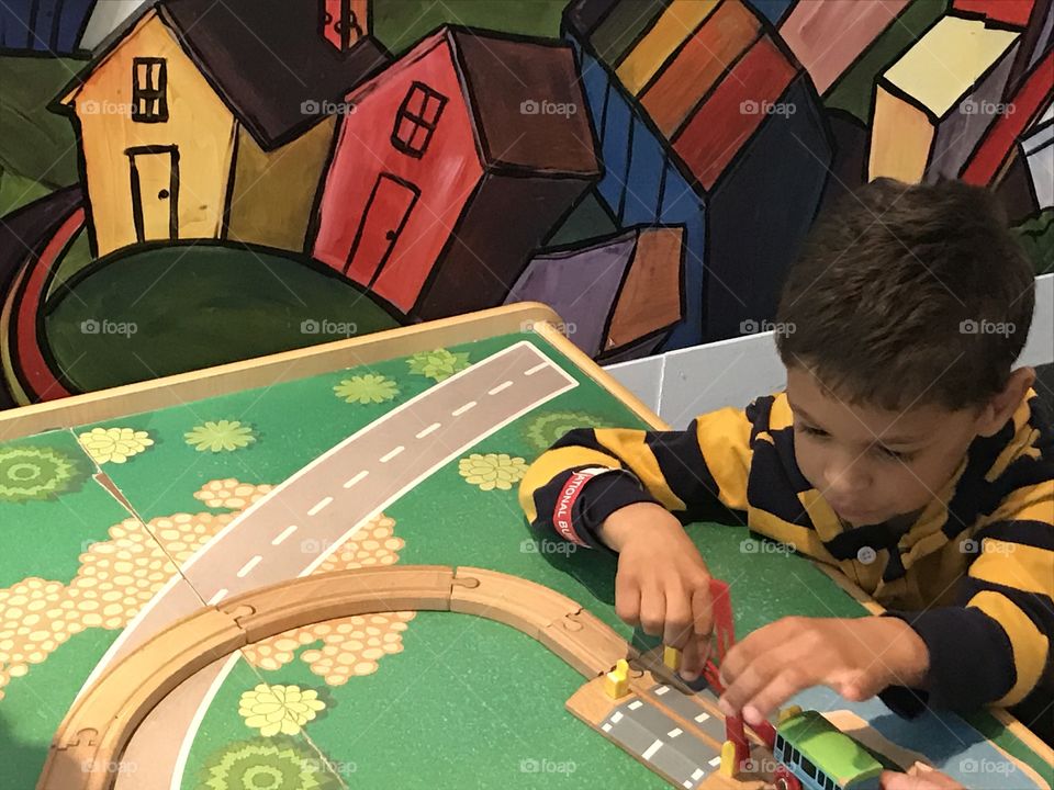 Boy playing with train at the National Building Museum 