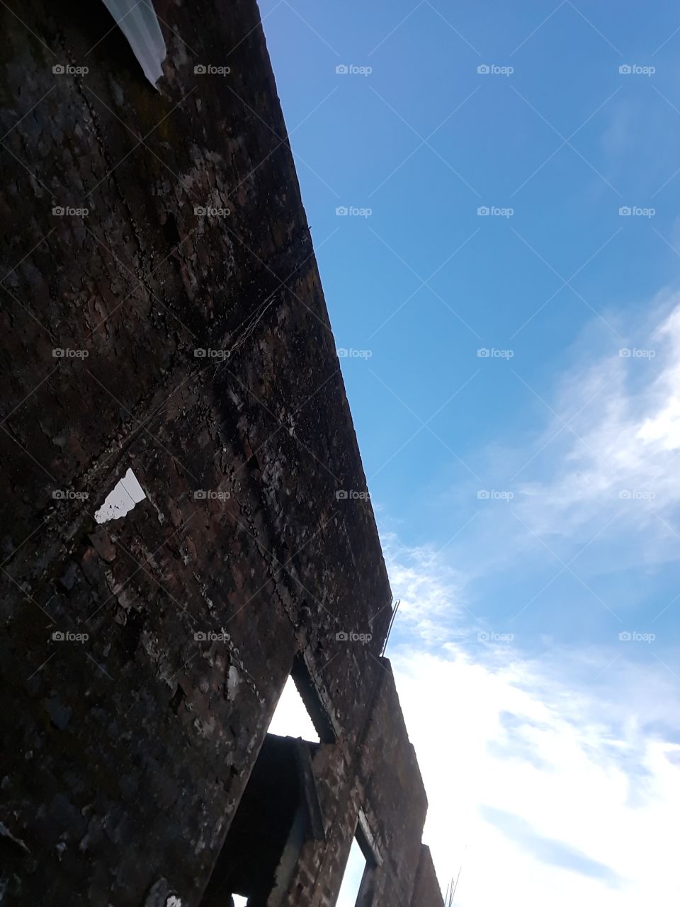 Blue sky with break old wall.