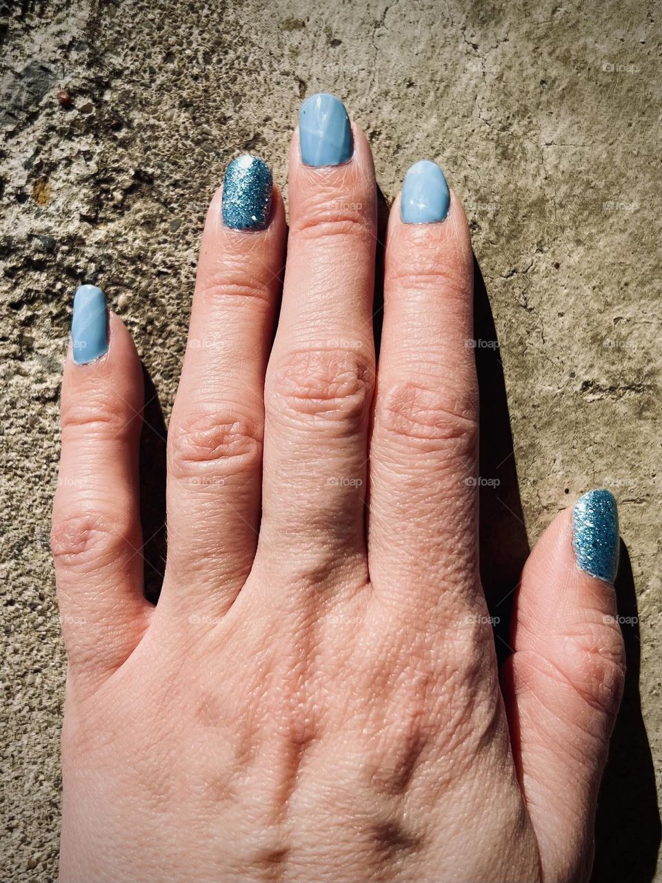 Soft and sparkly blue gel nail manicure 