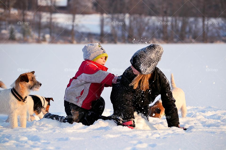 Brother playing with his sister in winter