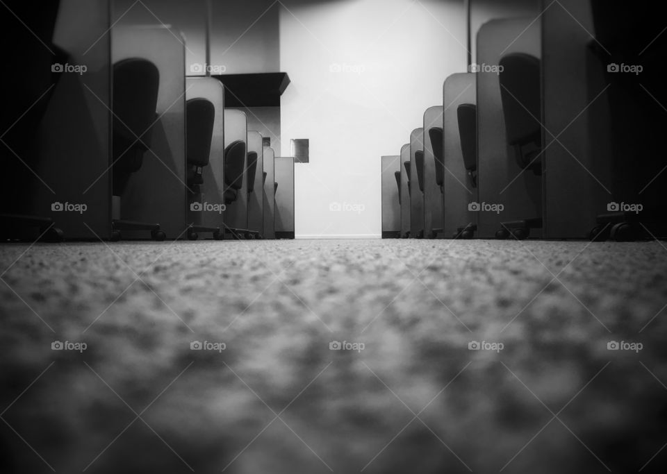 After hours in the office. Nothing but empty desks and chairs.