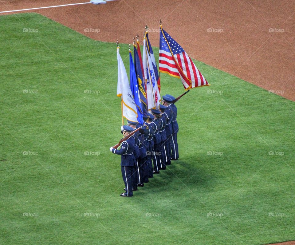 Stand with pride. Military holding flags at a baseball game in Arlington Texas
