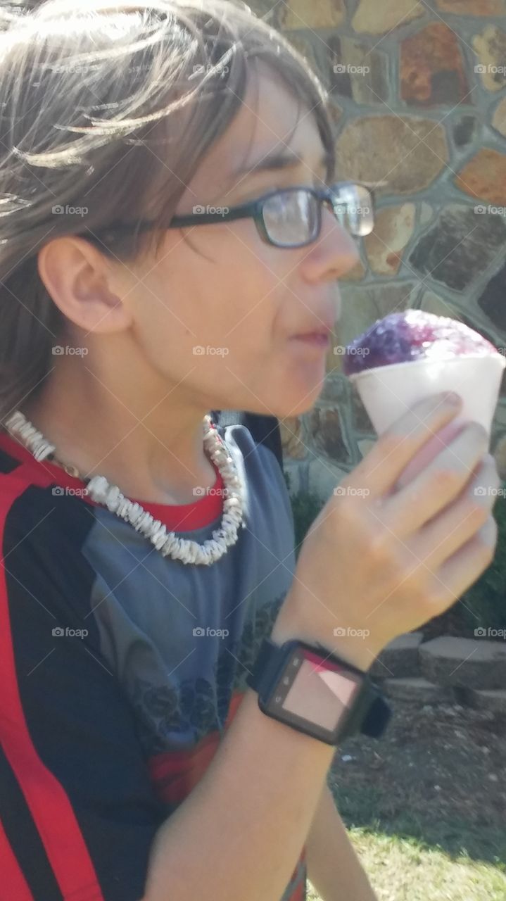 my son eating a snowcone on a hot day...