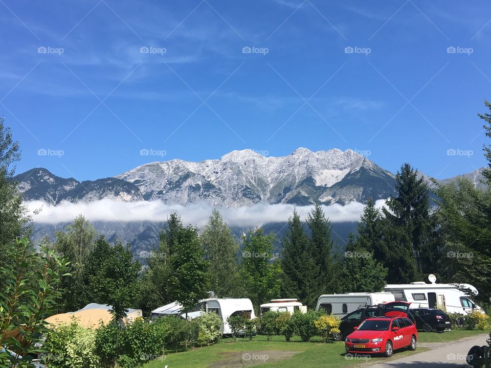 The view from a caravan site near the city of Innsbruck, Austria. Here is where we stayed for the weekend. The magnificent mountain in the background looms over the surrounding woodland, casting the many lakes below into darkness.