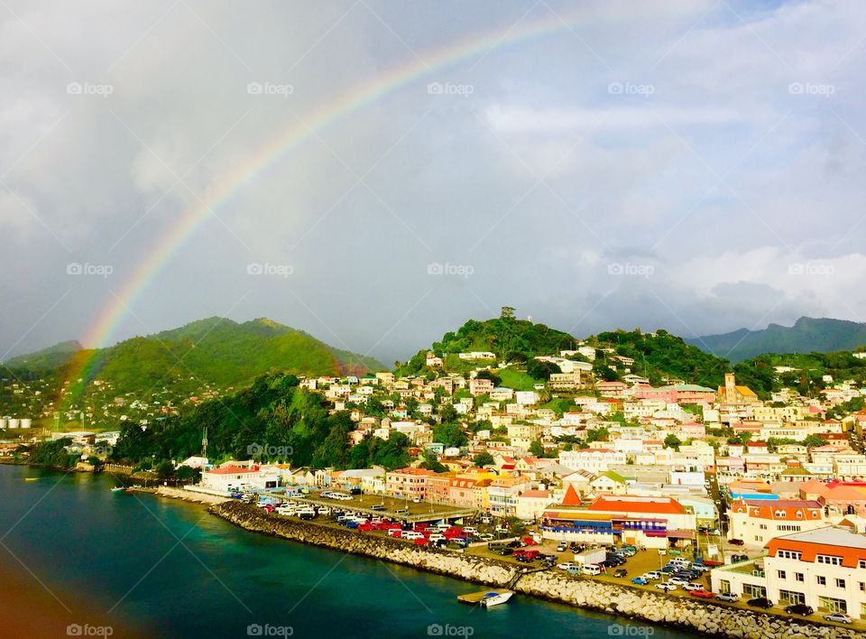 A rainbow of hope sheds light after the storm on this beautiful Caribbean island just as the tourists arrive to meet the poverty stricken locals 