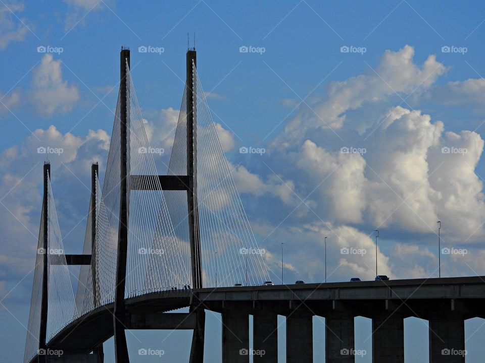 Car crossing a bridge with its iron structure high in the sky - From the ground up - What the world looks like from a “frogs perspective”