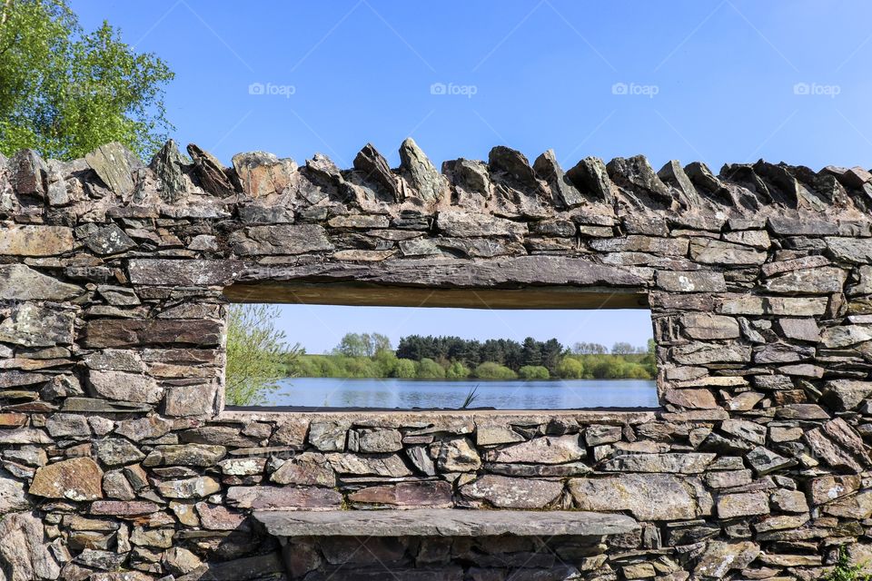Beautiful reservoir view from a rocky walls window 