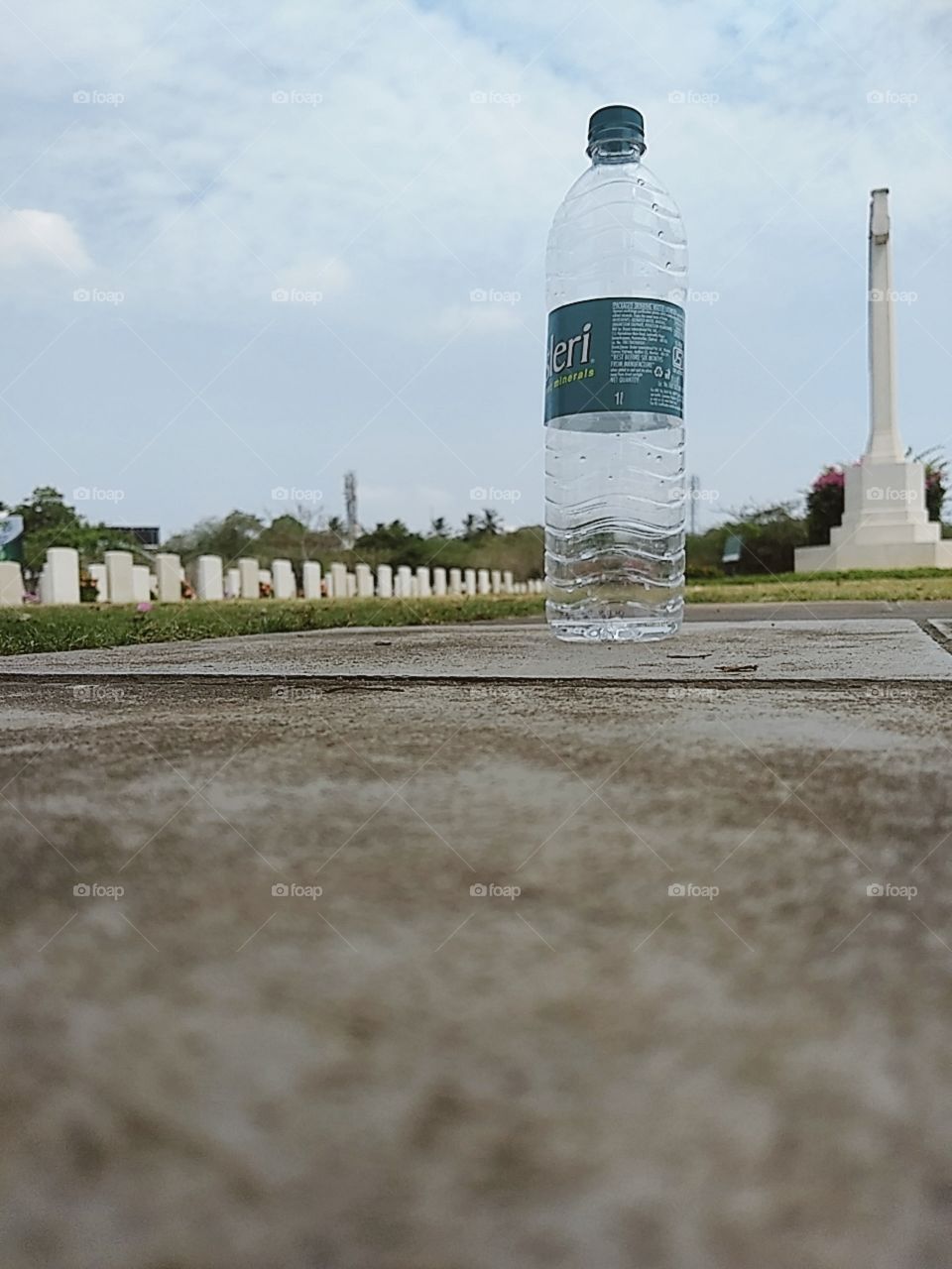 This empty bottle in between the gravyard reminds those who are under the grave.