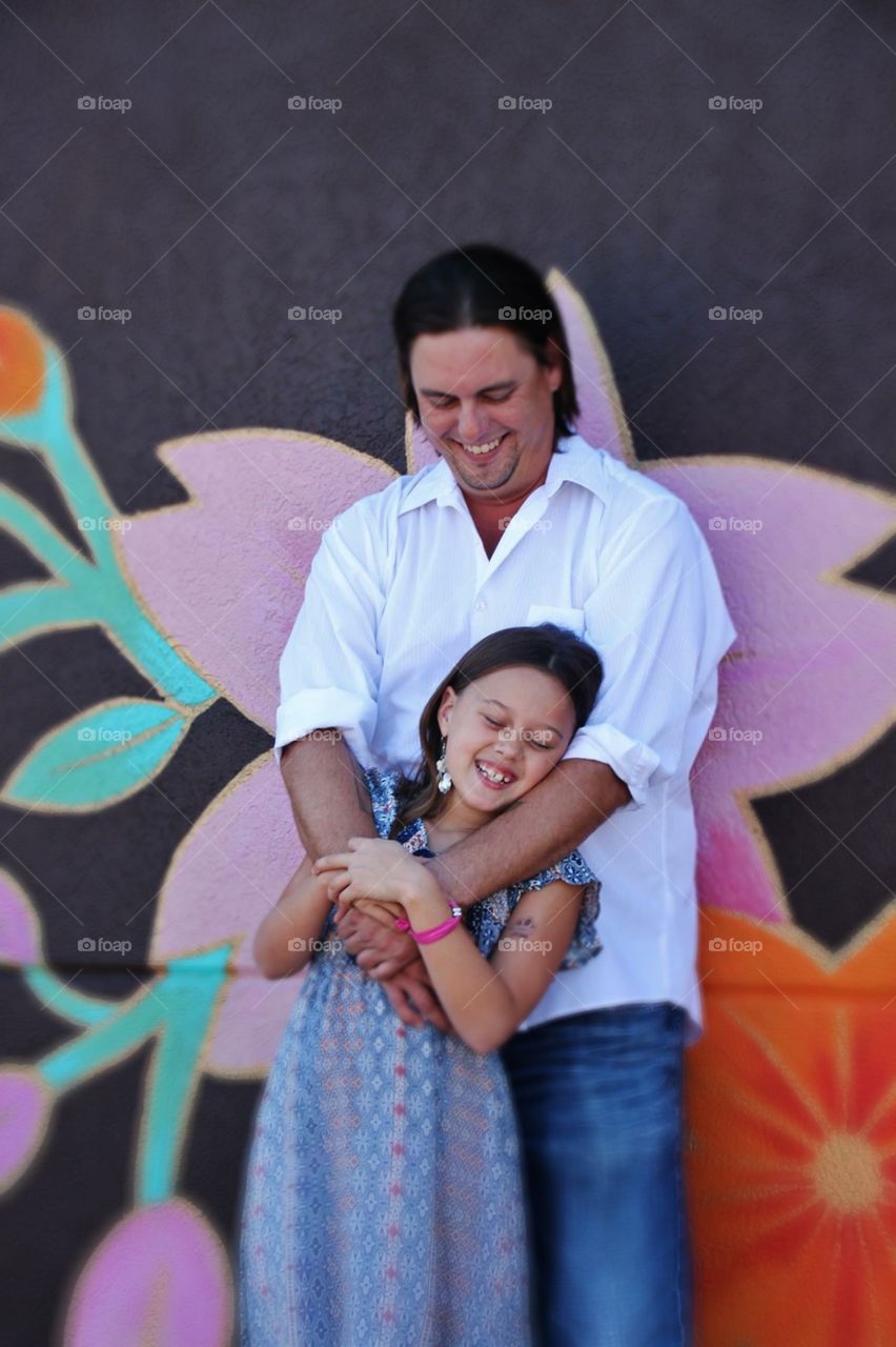 Daddy and Daughter in front of Mural