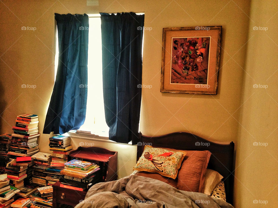 Cozy bedroom with stack of books