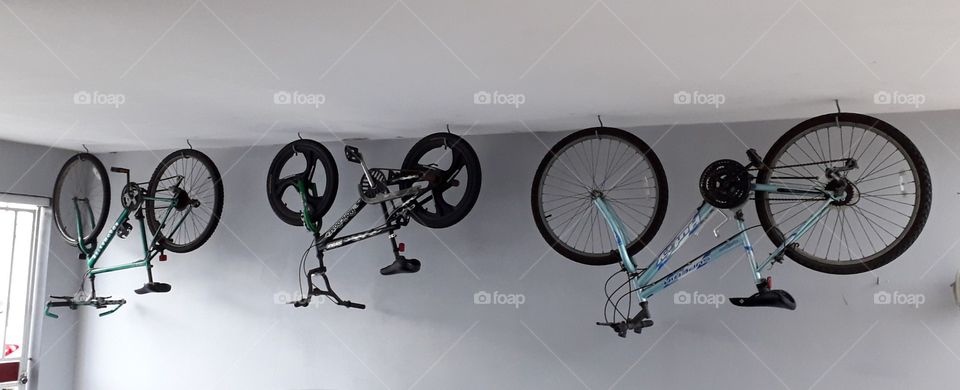 Family bicycles hanging on the garage ceiling