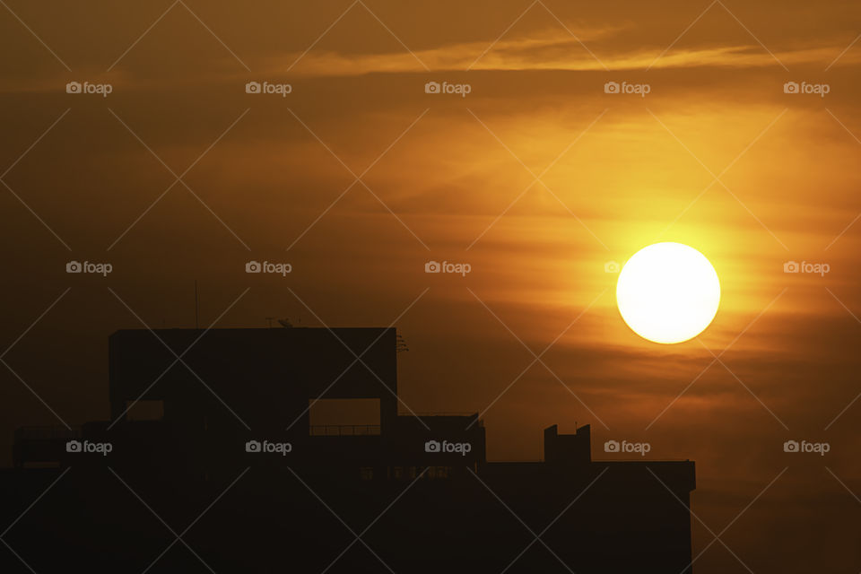 The early morning sunlight shining on large buildings.