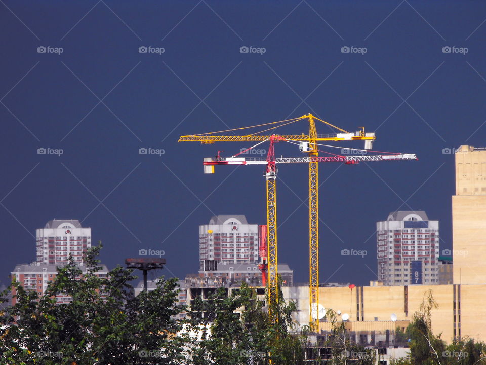 Building site cranes against an approaching storm in Moscow, Russia