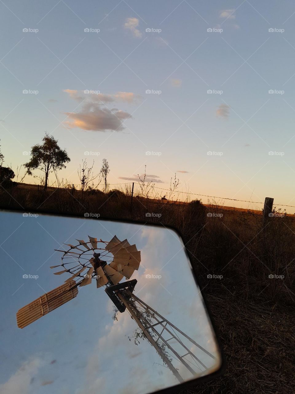 Windmill reflected in Rear vision Mirror