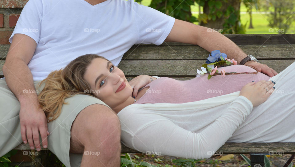 Pregnant woman lying on her husband's lap