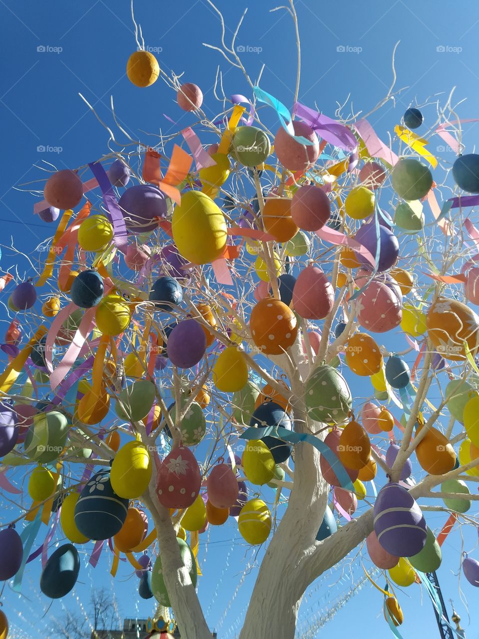 Artificial Multicolored eggs hang on a tree