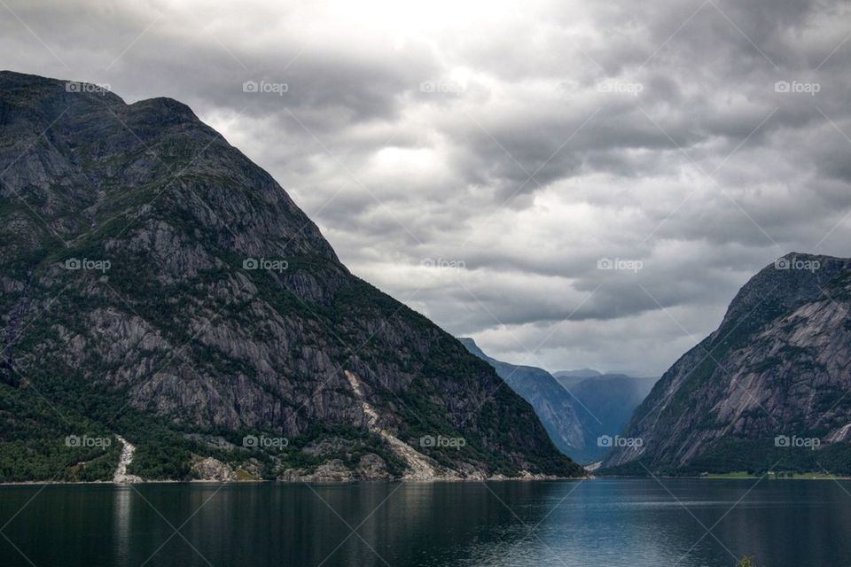 Scenic view of a mountains against cloudy sky